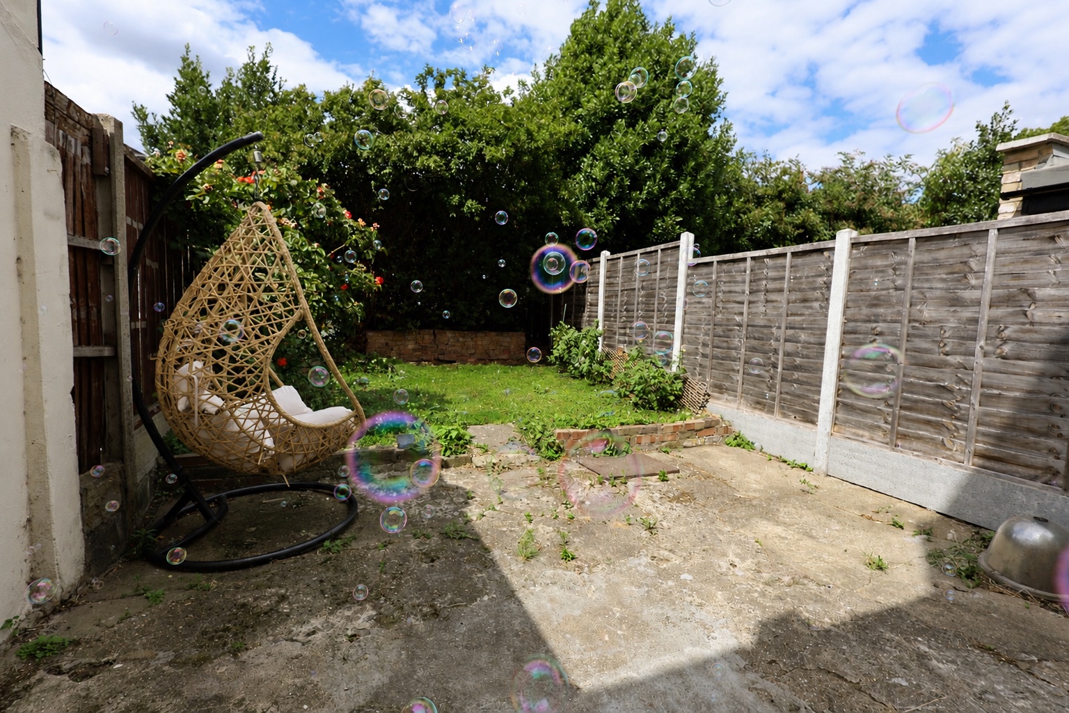 Bubbles floating across the Root and Bloom garden beside the hanging chair