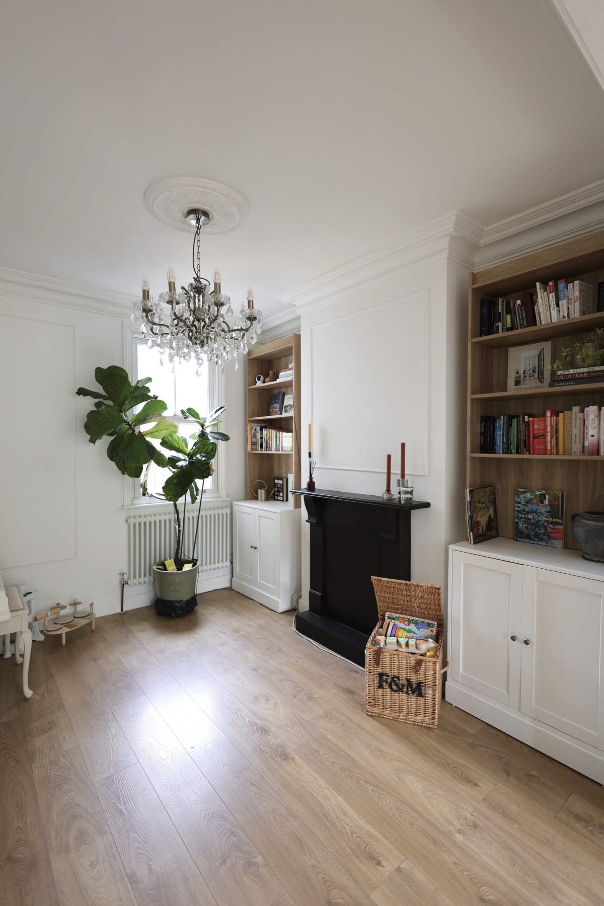 The fireplace, books and play basket in the main area