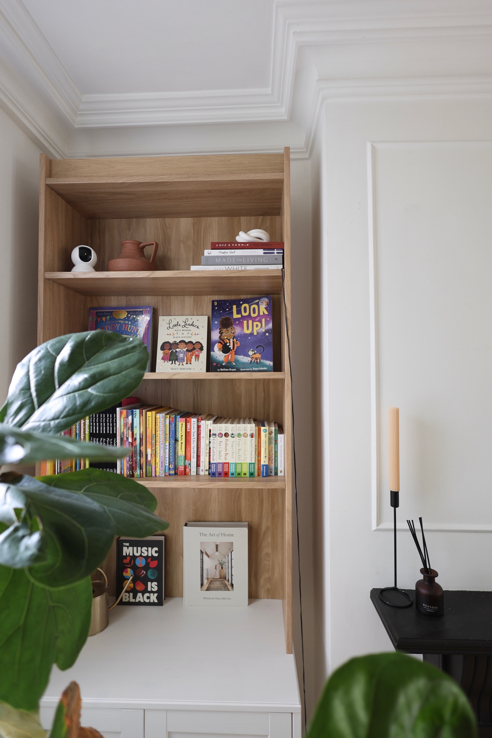 Children's books and natural details on the main area bookshelf
