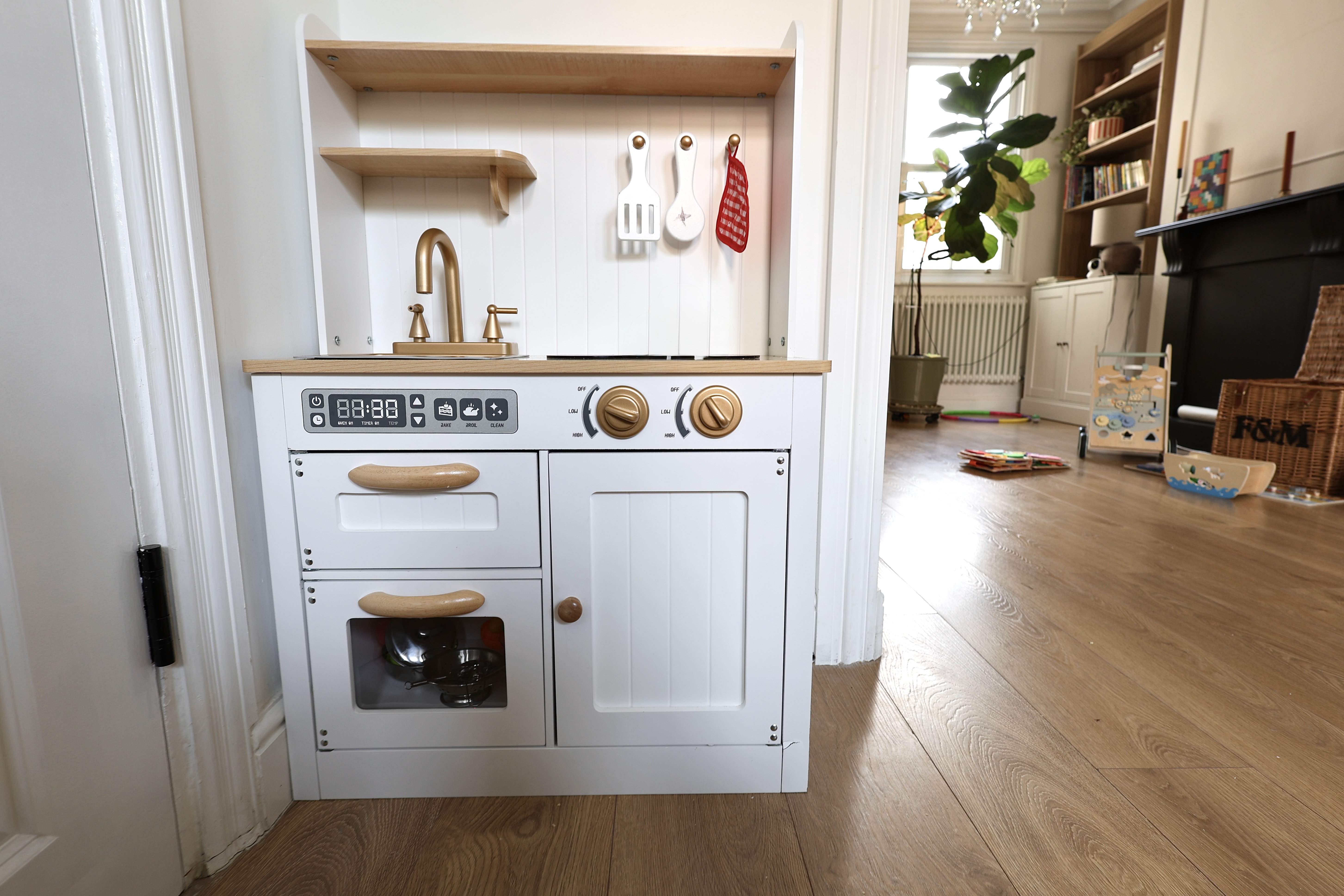 A children's play kitchen in the Root and Bloom main area