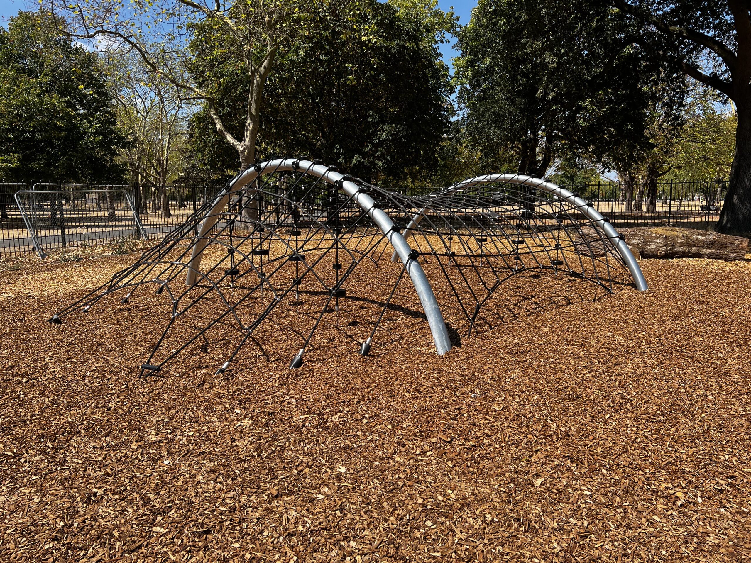 A rope climbing frame beneath the trees in West Ham Park